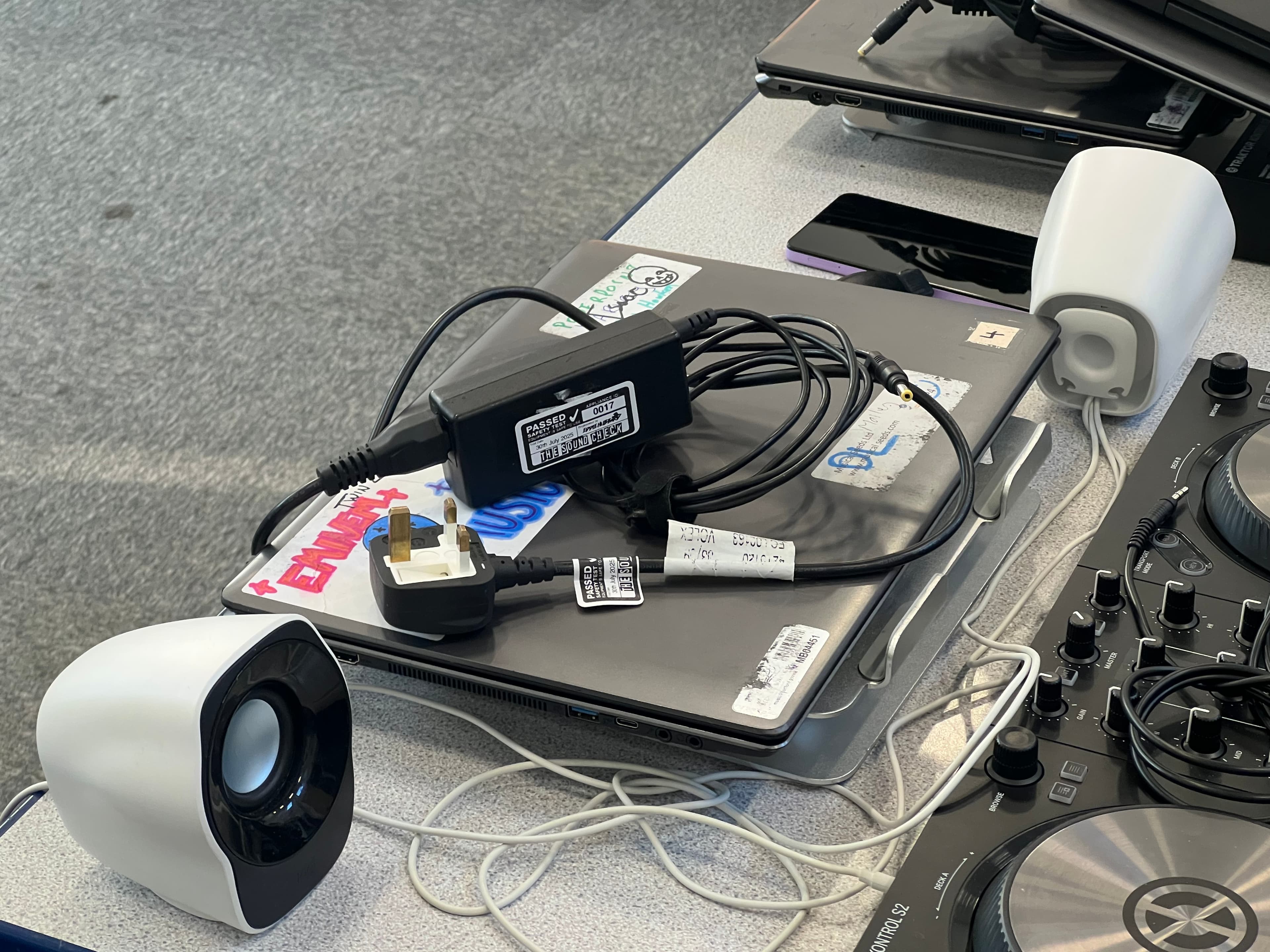 PAT testing setup on a desk with equipment and leads